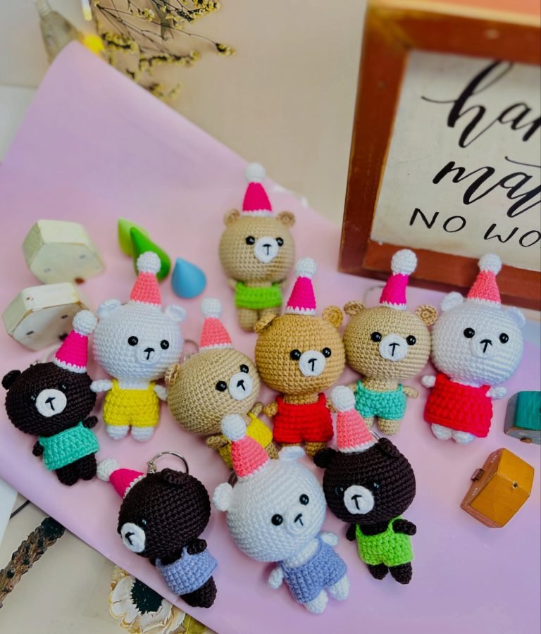 A tray of hand-crocheted bear keychains in many colours